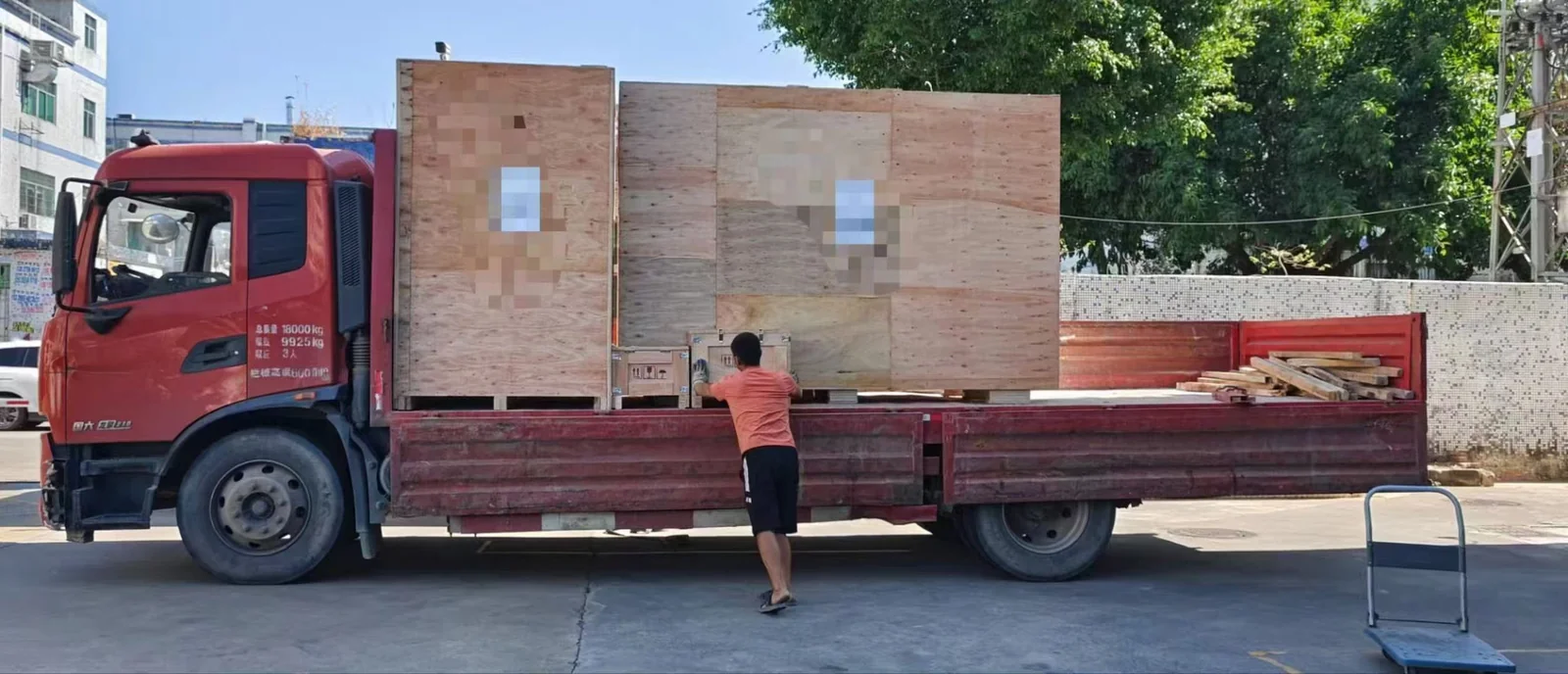 Truck being loaded with plywood crates